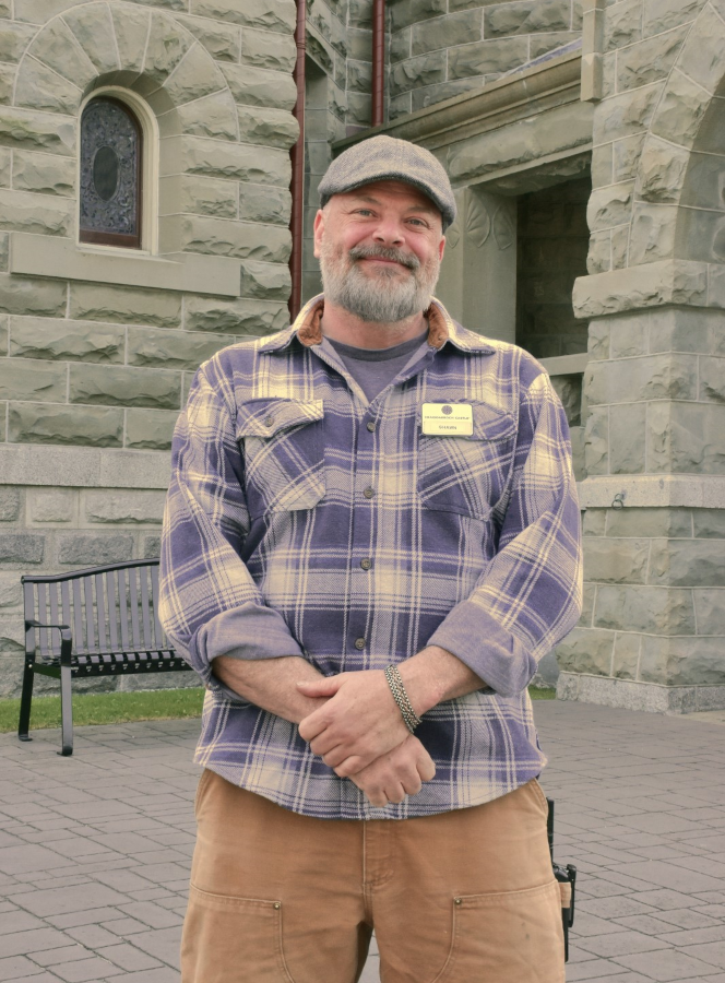 Building conservation manager standing in front of Craigdarroch Castle.